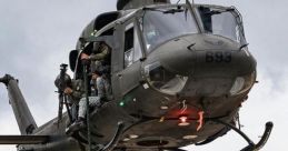 Soldier rappelling from a UH-1 helicopter during a tactical operation, showcasing military agility and aerial maneuverability.