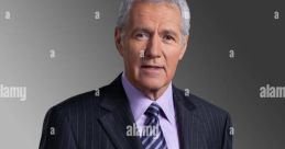 Alex Trebek, renowned host of Jeopardy!, dressed in a suit, gestures invitingly with a welcoming expression.