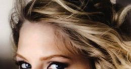 Taylor Swift showcasing her classic Fearless Era look with glamorous curls and bold eye makeup, perfect for fans and song enthusiasts.