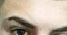 Close-up portrait of a confident young person with dark hair and expressive eyes, reflecting modern youth culture.