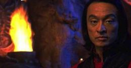 Cary Hiroyuki Tagawa as Shang Tsung in older years, posing with a mystical background, exuding dark power and mystery.