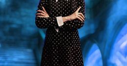 Wednesday Addams in a classic polka dot dress, showcasing her iconic look with a dark, mysterious backdrop.