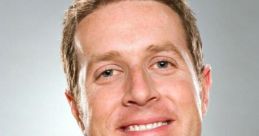 Geoff Keighley smiling against a gray background, known for hosting video game awards and industry events.