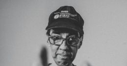 Portrait of a confident individual in a cap, showcasing a bold gesture, representing creativity and originality in Hollywood Factory.