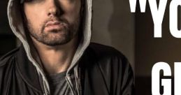 Eminem in casual wear, leaning against a wall with a serious expression, showcasing his iconic style and confidence.