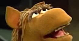 Buster the Horse, a beloved puppet by Martin P. Robinson, smiles brightly, showcasing his playful personality.