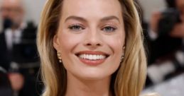 Margot Robbie smiles confidently at a high-profile event, showcasing her elegant black gown and radiant beauty.