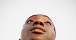 Young man looking up thoughtfully against a clear sky, embodying curiosity and aspiration. Ideal for Buddy DML and Cayla themes.