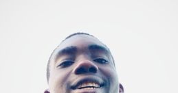 Smiling young man in a blue shirt, representing positivity and community engagement for Buddy DML International.