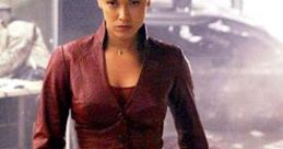Confident female villain in a fitted burgundy outfit, exuding power and allure in a dramatic, chaotic setting.