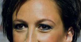 Close-up of Miranda Hart smiling confidently, showcasing her distinctive hairstyle and engaging expression at an event.