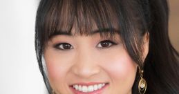 Portrait of Xanthe Huynh smiling in a sparkly black top, showcasing elegance and warmth in a professional setting.