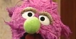 Humphrey, a lively purple puppet with a green nose and stylish tie, entertains and engages audiences with humor.