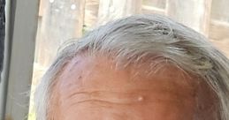 Close-up of an older man with gray hair and a mustache, conveying a thoughtful expression, possibly related to Deedo (The Recaller) 4.
