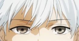 Kaneki Ken from Tokyo Ghoul with white hair and intense gaze, embodying the character's emotional depth in the English dub.
