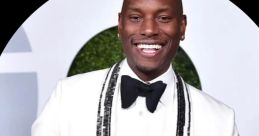 Tyrese Gibson in a stylish tuxedo with bead detailing, smiling confidently at a formal event.