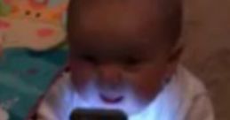 Infant excitedly interacts with a smartphone, showcasing the charm of kids and technology in playful moments.