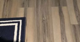 Wooden floor design with a navy blue rug, creating a cozy atmosphere for gaming or relaxation in "Deedo (The Recaller) 5.