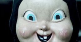 Creepy doll with a big smile, blue eyes, and dark attire, evoking chills reminiscent of horror themes.