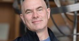 Scott Manley, renowned science communicator, poses confidently with arms crossed in a lab setting surrounded by equipment.
