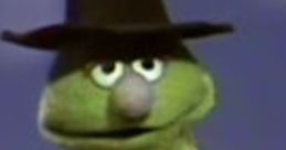 Lefty the Salesman from Sesame Street, wearing a hat and trench coat, showcasing his quirky personality and charm.