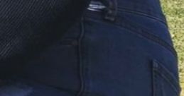 Close-up of blue jeans worn by Danielle Jauregi, showcasing a stylish casual look against a green outdoor background.