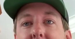 Cleetus McFarland smiling, wearing a green cap, showcasing his casual style and warm personality.