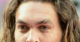 Close-up of Jason Momoa showcasing his intense gaze and signature long hair, known for his powerful voice and charismatic presence.