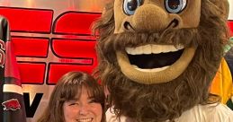 Excited fan holding a rose poses with the mascot of the Naturals on the Ruscin and Zach Show set.