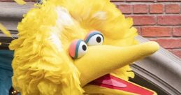 Big Bird puppet by Matt Vogel showcasing its vibrant yellow feathers and expressive face in a playful setting.