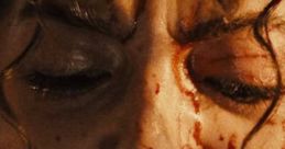 Isabela Merced expressing intense anger, blood on her face, capturing a powerful emotional moment in a dramatic scene.