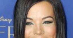 Jackie Redmond showcases a radiant smile, wearing a stylish blue top with a sleek hairstyle at a recent event.