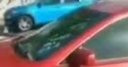 Red car parked beside a blue vehicle, capturing the vibrant urban atmosphere related to the "7000 Dollars Guy" trend.