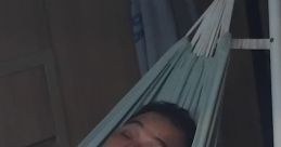Man relaxing in a hammock at home, embracing a laid-back lifestyle with low-budget comfort in a casual setting.