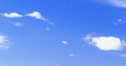 Lush green hill under a bright blue sky with fluffy clouds, symbolizing tranquility and natural beauty in a vibrant landscape.