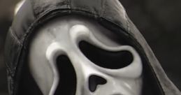 Ghostface mask from Scream, featuring a menacing expression and a bloody knife, embodies classic horror themes.