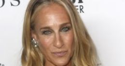 Sarah Jessica Parker in a stunning purple lace dress, showcasing her glamorous style at a red carpet event.