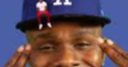 DaBaby sports a blue LA cap, flashing a big smile while posing playfully for the "DABABY HA" vibe.