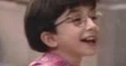 Cheerful child with glasses, wearing a vibrant patterned shirt, enjoying playtime outdoors. Perfect for Tarah (Elmocize) fans.