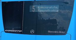 Blue Mercedes-Benz bus displaying route 5, serving Rakosfalva and Kossuth utca for public transportation in Budapest.