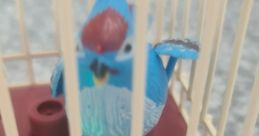 Colorful toy bird inside a cage, featuring vibrant blue and red accents, with a light-up base for added fun.