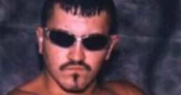 Jamie Dundee striking a confident pose, showcasing his tattoos and sunglasses, embodying the wrestling persona.