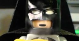 Lego Batman holds a yellow mug with an iconic logo, ready for action amid the backdrop of a futuristic setting.