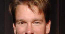 JBL, former WWE champion, smiling in a formal suit at an event, showcasing his signature style and charisma.