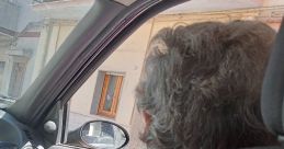 Close-up of a person in the car looking out the window, reflecting a moment of everyday life in La Barese.