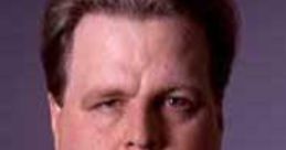 Mark Madden's stern expression, showcasing a serious demeanor and distinctive style in a close-up portrait.