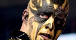 Goldust showcasing his iconic face paint and elaborate costume during a wrestling match in a dynamic pose.