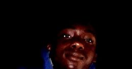 Portrait of a young man wearing a blue hoodie, showcasing a determined expression and an "N05" badge amidst darkness.
