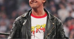 Roddy Piper in a leather jacket and kilt, showcasing his iconic style during a wrestling event.