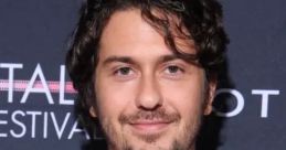 Nat Wolff smiling at a film festival, showcasing his trendy style, a rising talent in entertainment and AI voice projects.